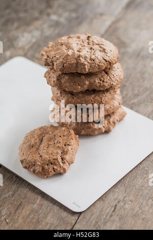chocolate chip cookies, meringue with cracks on a rustic background. Stock Photo