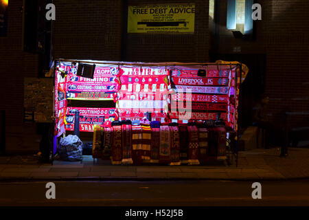 LIVERPOOL UK 17th OCTOBER 2016. Stalls selling scarves outside Liverpool Football Club's stadium at a nighttime game Stock Photo