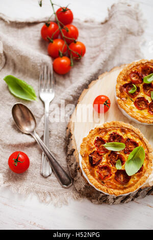 Homemade tomato tartlets with basil leaves Stock Photo