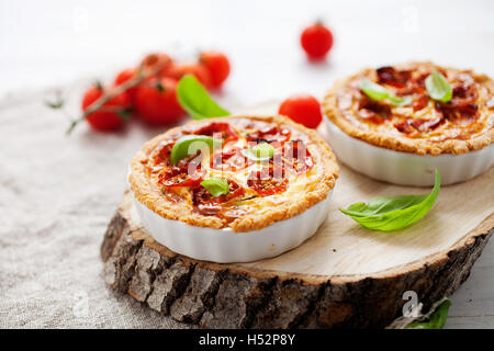 Homemade tomato tartlets with basil leaves Stock Photo