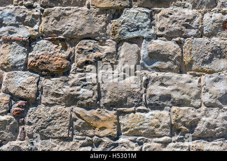 Background from an rough brown natural stone wall Stock Photo