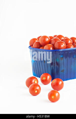 blue plastic box full of tomatoes isolated. Stock Photo