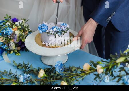 Bride and groom at wedding cutting the  cake Stock Photo