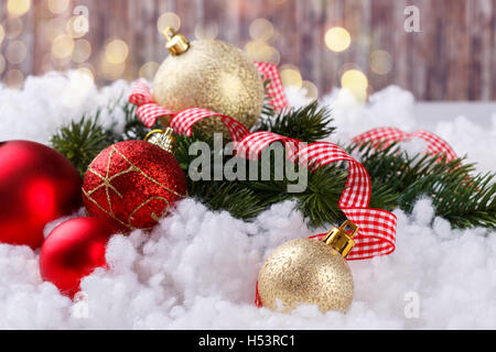 Christmas decoration with red and golden balls and snow flakes on white snow background,selective focus Stock Photo