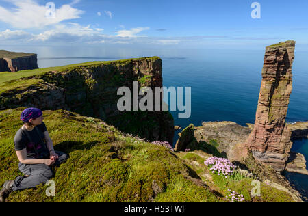 Female tourist looking towards the Old Man of Hoy, Hoy, Orkney Islands, Scotland. Stock Photo