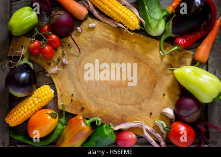 Composition with assorted organic raw vegetables. The concept of a healthy diet or detox diet, on a wooden background. Space for Stock Photo