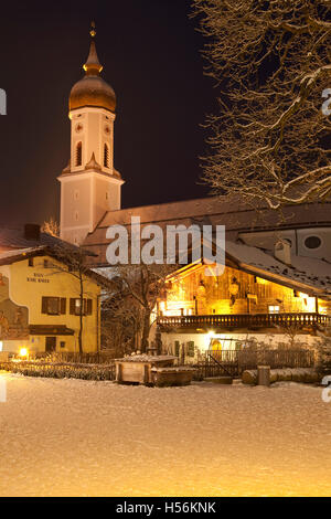 Town view with St. Martin parish church, public library, Mohrenplatz square, snow, blue hour, Garmisch-Partenkirchen Stock Photo