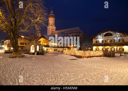 Town view with St. Martin parish church, public library, Mohrenplatz square, snow, blue hour, Garmisch-Partenkirchen Stock Photo