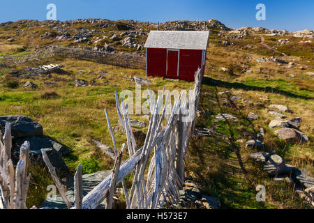 A rocky field with a traditional wooden enclosure in rural Newfoundland, Canada. Stock Photo