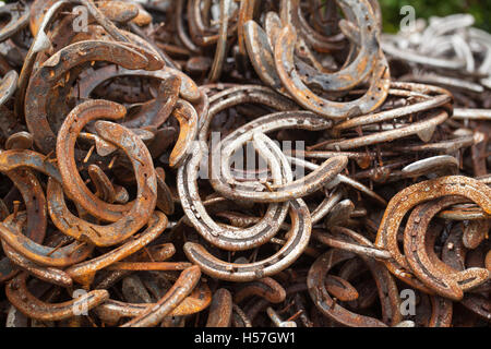 Horseshoes. Pile of used worn metal horseshoes. Outside a blacksmith farriers premises. Leicestershire. England. UK. Stock Photo