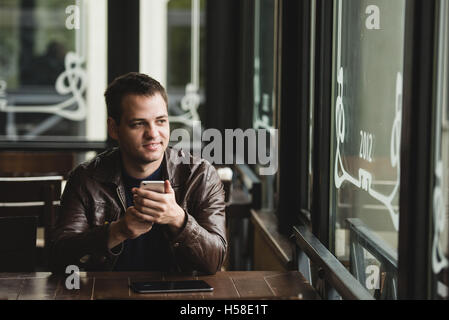 Man using a smartphone in the cafe Stock Photo