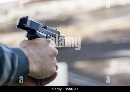 Gun Fire Street Assault. Shooting a Handgun and Smoke Coming out of Barrel. Stock Photo