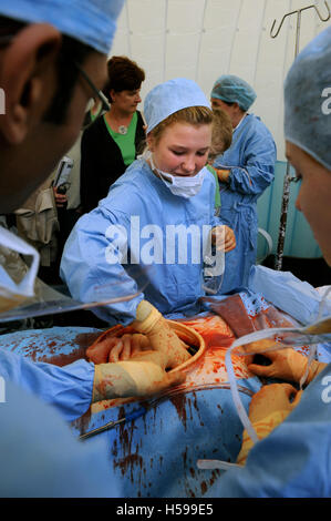 Schoolchildren invited to participate in a simulated surgical operation with a film and tv dummy made by the make-up and prosthe Stock Photo