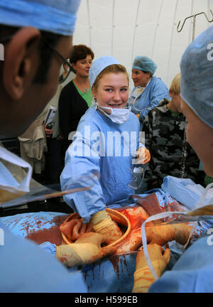 Schoolchildren invited to participate in a simulated surgical operation with a film and tv dummy made by the make-up and prosthe Stock Photo