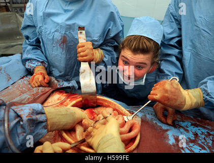 Schoolchildren invited to participate in a simulated surgical operation with a film and tv dummy made by the make-up and prosthe Stock Photo