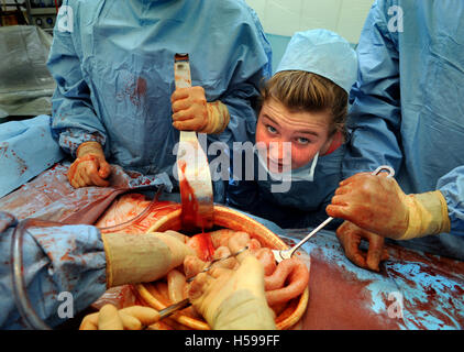 Schoolchildren invited to participate in a simulated surgical operation with a film and tv dummy made by the make-up and prosthe Stock Photo