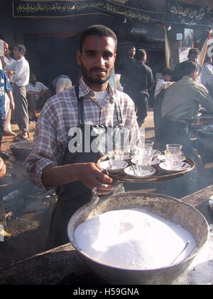 22nd April 2003 During the first Ashura after the fall of Saddam, a tea-seller is doing a roaring trade in Karbala, Iraq. Stock Photo