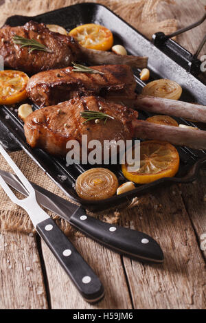 Tomahawk steak with vegetables and a knife on the table. Grilled meat ...