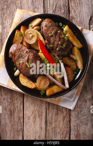 Beef steak with chili and fried potatoes on a plate. vertical top view Stock Photo