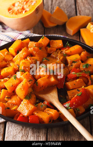 Vegetarian food: pumpkin curry on a plate close-up. Vertical Stock Photo