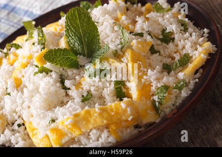 Cauliflower rice with egg and mint for the Palio on a plate macro. horizontal Stock Photo