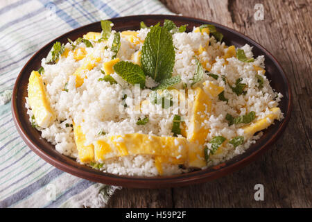 Cauliflower rice with egg and mint for paleo close-up on the table. horizontal Stock Photo
