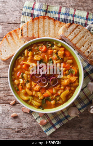 Italian ribollita vegetable soup close up in a bowl on the table. vertical view from above Stock Photo