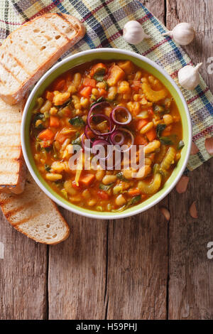 Italian ribollita soup close up in a bowl on the table. vertical view from above Stock Photo