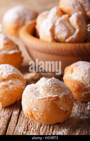 Festive Italian donuts Castagnole close up in a bowl on the table. vertical Stock Photo