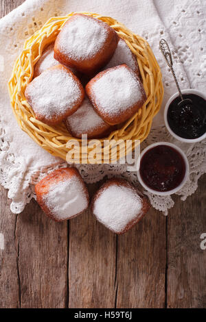 Sweet hot donuts with powdered sugar and jam on the table. vertical view from above Stock Photo