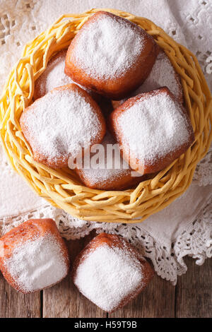 French beignets donuts with powdered sugar close-up on the table. Vertical view from above Stock Photo