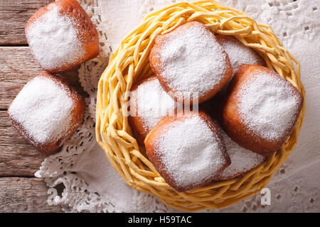 French beignets donuts with powdered sugar close-up on the table. horizontal view from above Stock Photo