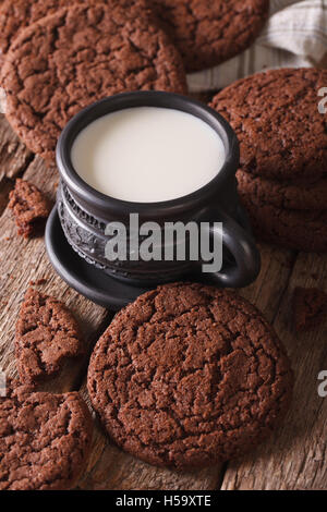 Homemade chocolate cookies and milk on the table close-up. vertical Stock Photo