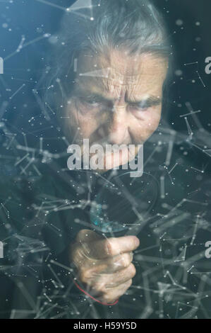 The cyber criminal person using a magnifying glass in deep web cyberspace. Selective focus. Stock Photo