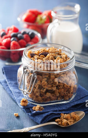 homemade healthy granola in glass jar and berries Stock Photo