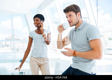 Smiling woman and man working and discussing project in office Stock Photo