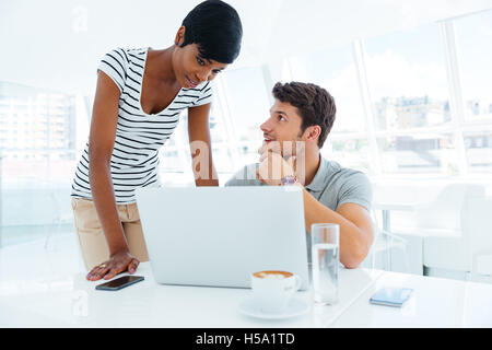 Group of two young smiling businesspeople working together in conference room Stock Photo