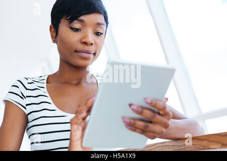 Attractive afro american businesswoman using tablet computer in office Stock Photo