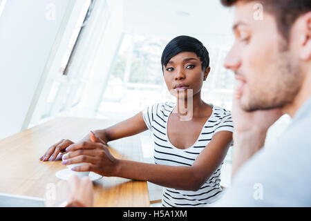 Two young businesspeople having meeting in office Stock Photo