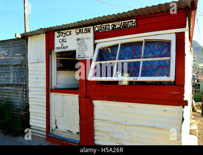 Typical shop, hair salon,  in the 'shack settlements' township in Imizamo Yethu,commonly known as Mandela Park, Hout Bay, Cape Town, South Africa Stock Photo