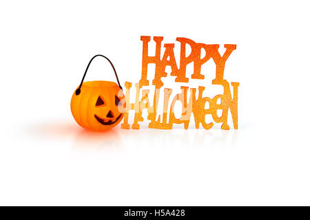 Halloween concept with a orange glowing pumpkin shape tealight candle holder and a Happy Halloween sign on a white background Stock Photo