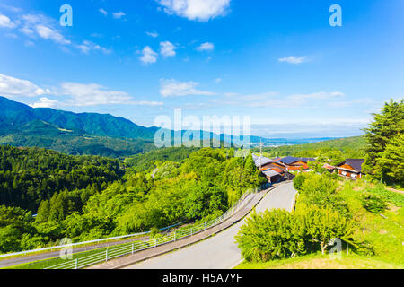 A view overlooking Kiso Valley above Magome village on the Nakasendo Route in Japan on a blue sky day Stock Photo