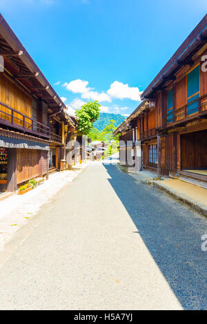 Traditional wood structures line the sides of the main street of Tsumago on the Tsumago-Magome portion of Nakasendo route in Gif Stock Photo