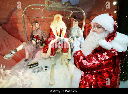 Father Christmas stands outside and admires the Christmas window displays themed as 'Shine on', at Sefridges department store in Oxford Street in central London. Stock Photo