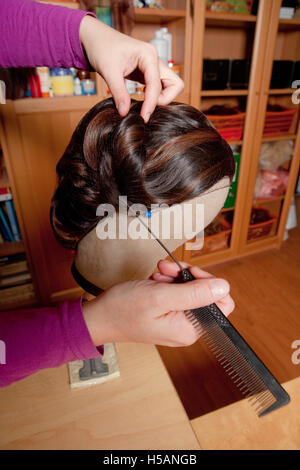 Professional Wig Maker Working in her Workshop. Stock Photo
