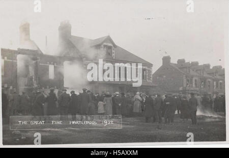 This image captures a burned-out street, likely after a fire or disaster, showing the aftermath of destruction. The scene depicts a street heavily damaged by fire, with buildings in ruin. Stock Photo