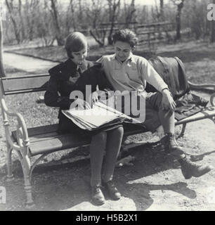 This image shows a young woman and man reading Braille on a park bench in Austria. The photograph reflects their engagement with accessible literature, capturing an aspect of Jewish life and culture, documented by the Leo Baeck Institute. Stock Photo