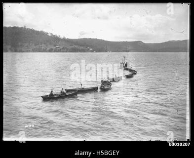 Rowing boats being towed to starting area Stock Photo