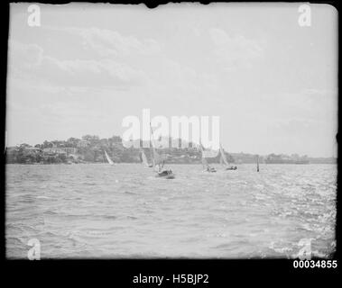 3 Six-metre class yachts racing on a harbour Stock Photo