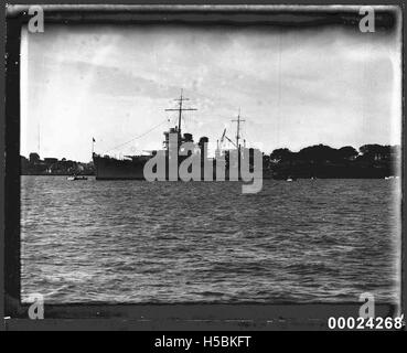 USS ASTORIA at anchor in Farm Cove, Sydney Stock Photo